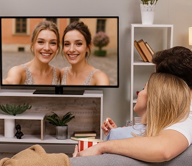 couple watching wedding photos on apple tv