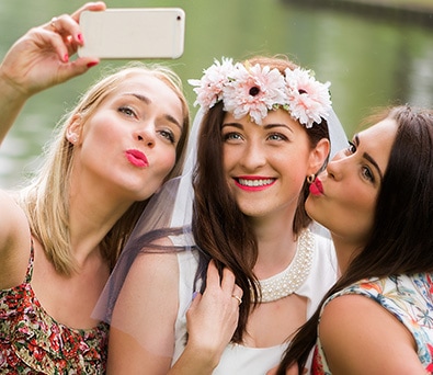 Friends share photos at a wedding using Tapestry Show App